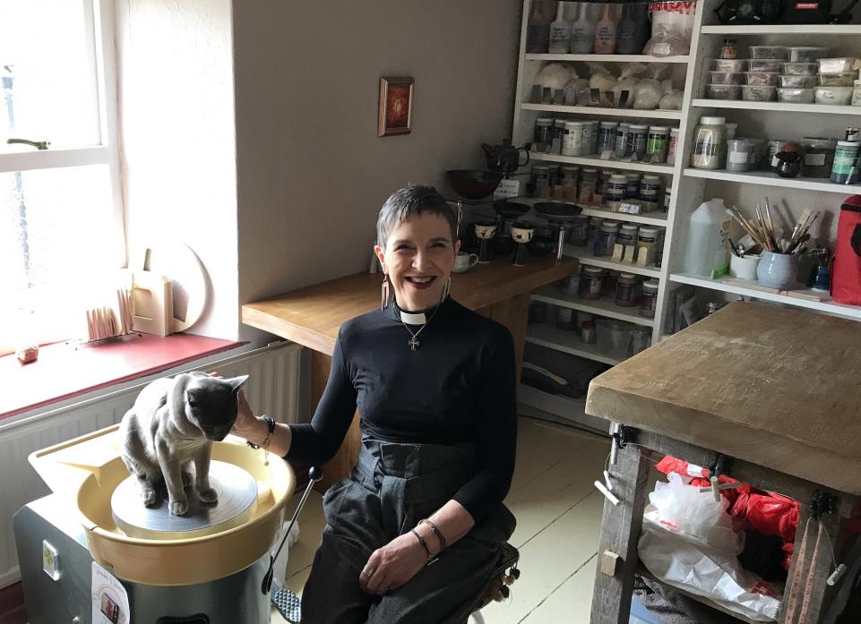 AT THE WHEEL: Potter and priest Judith Walker-Hutchinson with Greebo, the studio cat