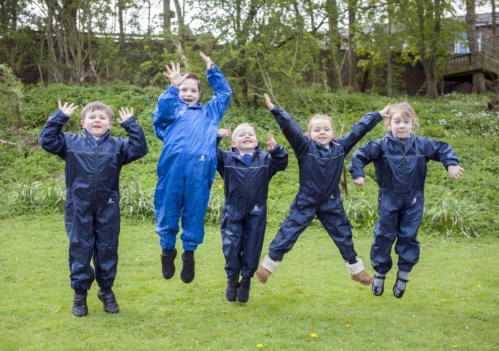 JUMPING FOR JOY: Children at Ramshaw primary school wearing their new all-weather clothing which was purchased for outdoor activities thanks to CA Group