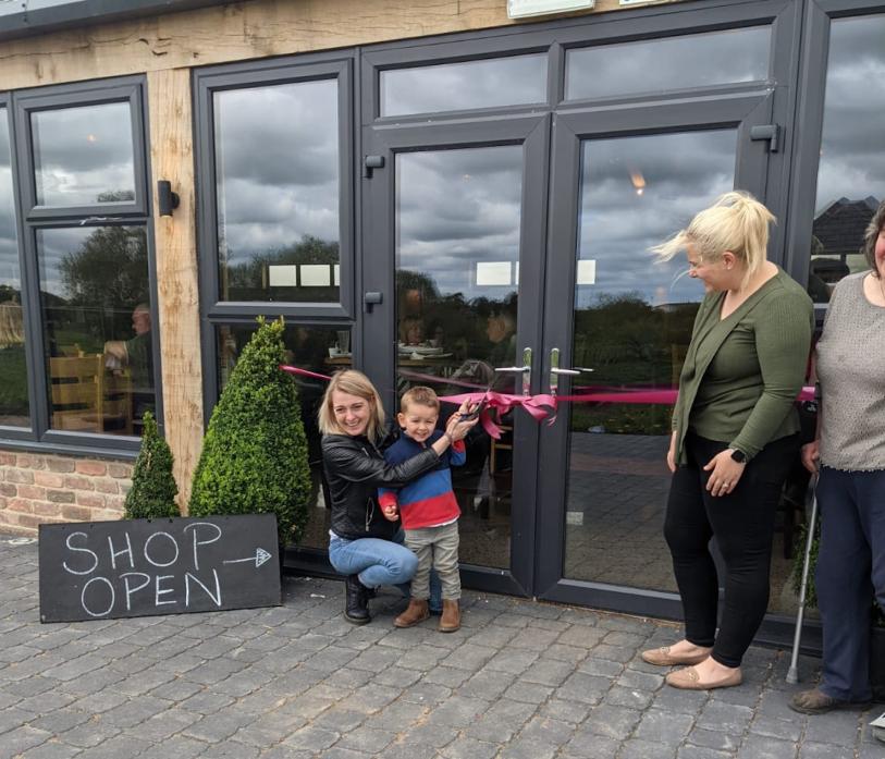 OPEN FOr BUSINESS: MP Dehenna Davison got a helping hand cutting the ribbon when she officially re-opened the Mill Kitchen at Broom Mill. She is pictured with Rachael Betney, right