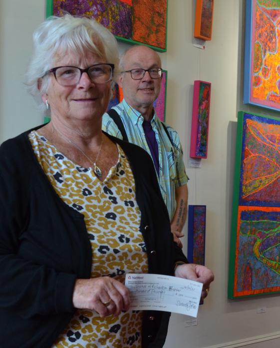 CHEQUE THIS OUT: Pauline Harrison, chairwoman of the Friends of Richardson Hospital, accepts a cheque for £100 from artist Simon Pell