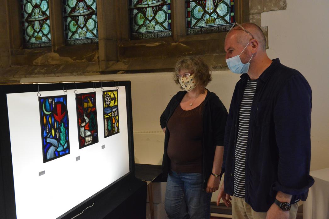 SKILLED CRAFT: Stained glass artist Christian Ryan explains some of the artworks to Kim Harding during the exhibition at St Mary’s Parish Church, in Barnard Castle									     TM pic
