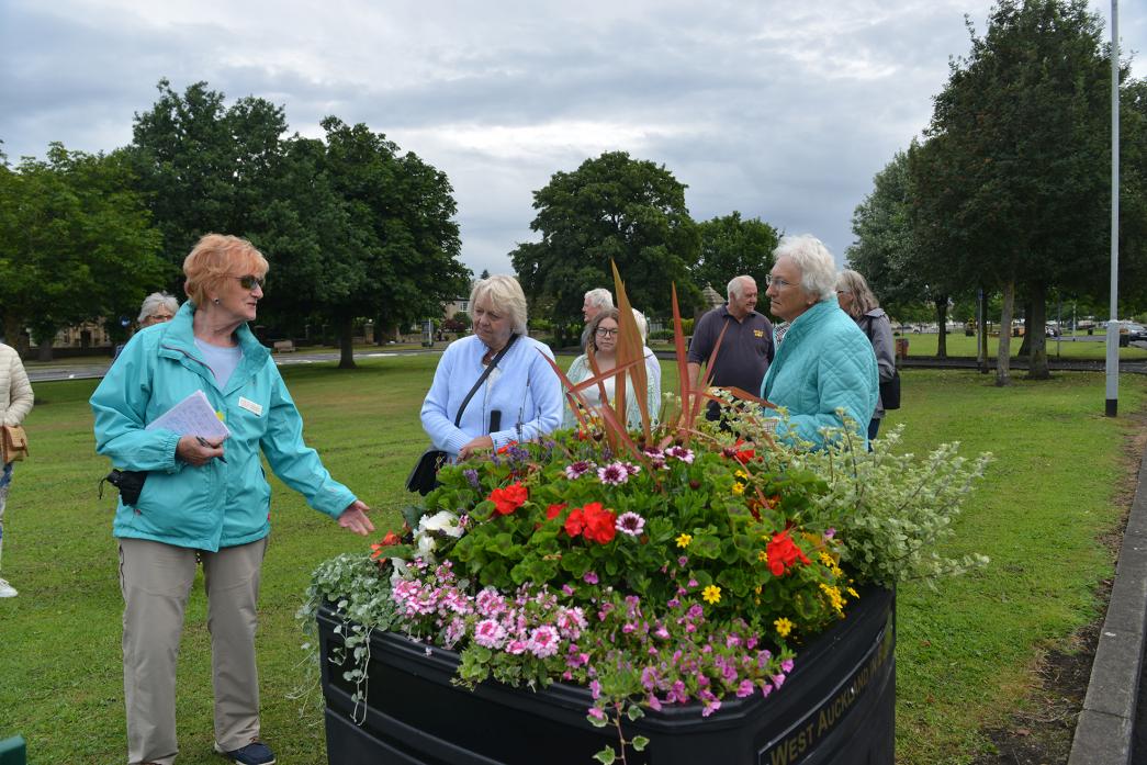 BLOOMING LOVELY: West Auckland-in-Bloom organisers Jean Pattison and Audrey Beck show the judges some of the floral displays on the village green