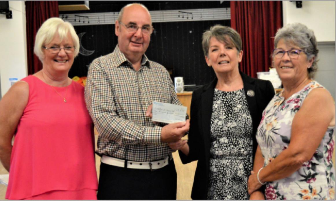 DANCING THE NIGHT AWAY: Klara Whiley, Butterknowle Village Hall secretary, presents the cheque for £300 to Andrew Hooper from the Butterknowle Dance Club, wtached by the dance club's Ann Galvin, left, and village hall booking secretary Heather Dunn
