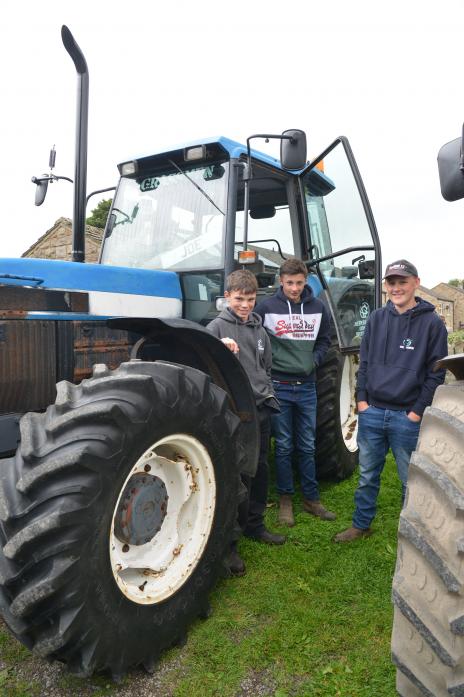 Young tractor enthusiasts Aidan Marmont, Joe Scott and Lewis Wilkinson with Joe’s 1999 New Holland 70/4