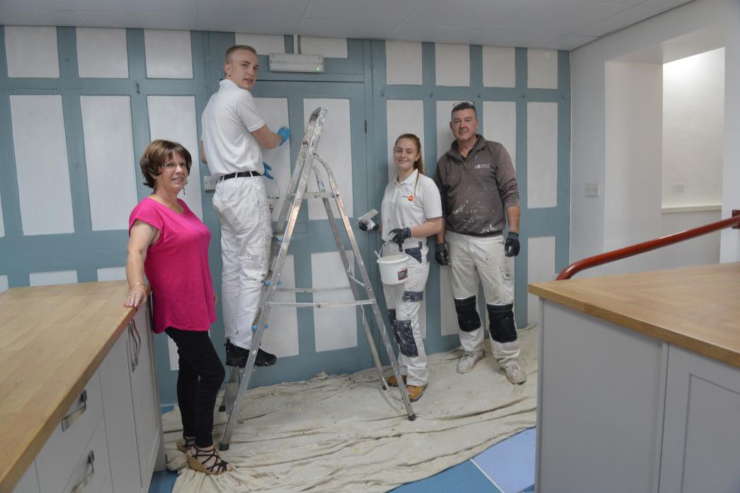 PANEL WORK: Tradesman Nigel Stevens with students Alex Pickering and Cameron Southworth while Beverley Redfearn from Stainton Village Hall looks on