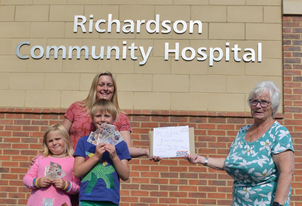 MUCH-NEEDED: Jennie Lee and her children Jake and Isla hand over the £500 raised through their scarecrow trail to Pauline Harrison of the Friends of Richardson Hospital