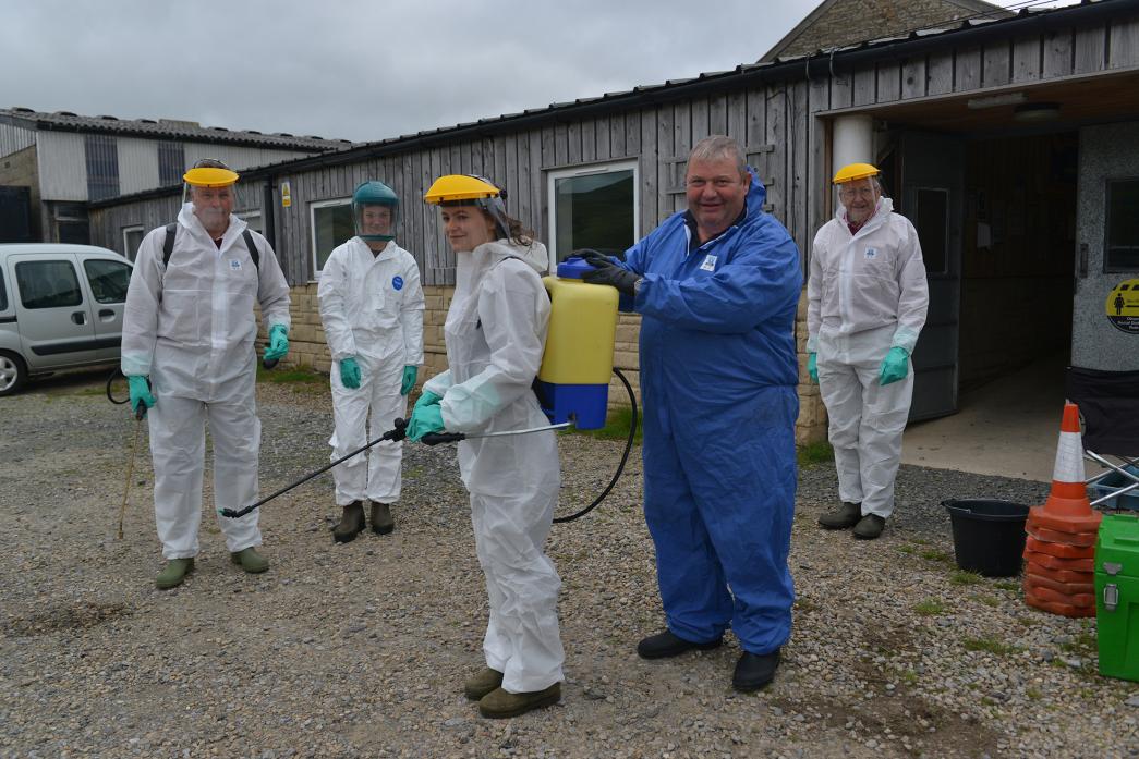 SPREADING EXPERTISE: Trainer Campbell Logue ensures Holly Teward’s knapsack spray is correctly fastened while trainees Mark Humble, Carrie Worgan and Maurice Oxley look on