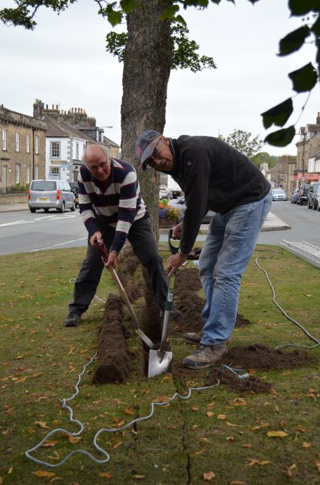 DIGGING IN: Volunteers Geoff King and Tim Raw prepare a trench for a cable to take power to one of the trees in Galgate greens