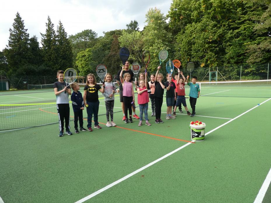 MAKING A RACKET: Coach Sam Stokoe with some of the junior tennis players during their training session on Sunday