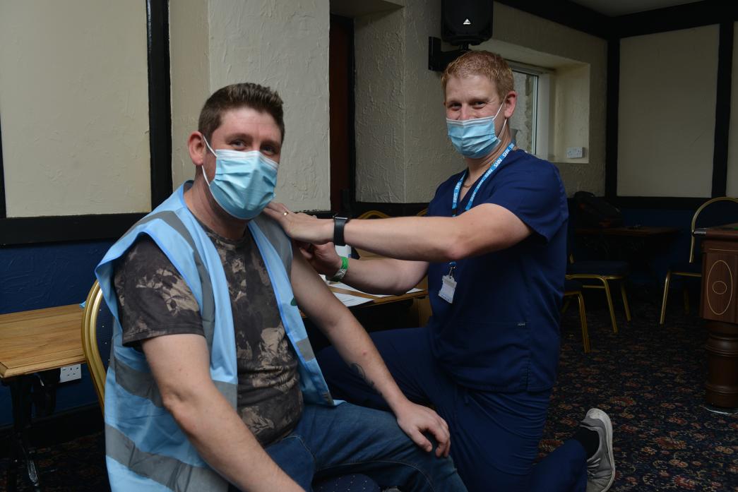VACCINE: Pharmacy manager Pete Horrocks gives pub manager Dan Richards a flu jab at The Edge Hotel, in Woodland