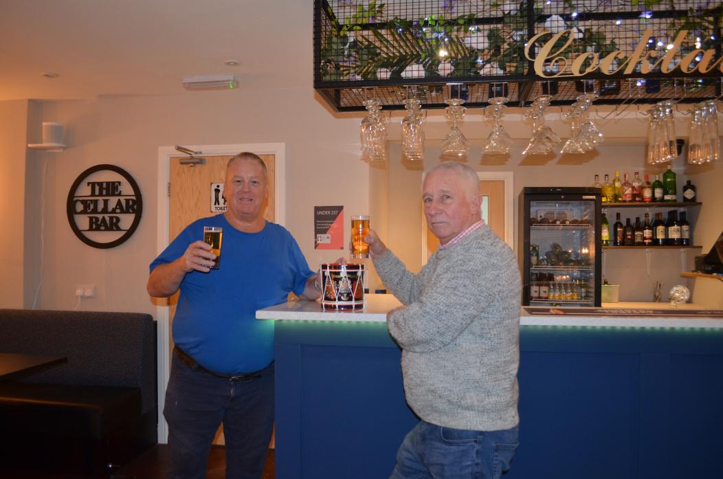 CHEERS: Mine host Steve Green, owner of the Three Horse Shoes, raises a glass with former DLI treasurer Eddie Tinkler in the converted club