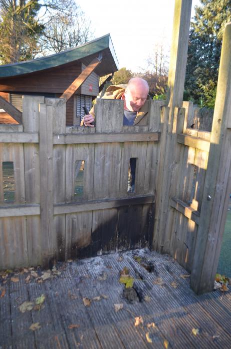 ANOTHER ATTACK:  Town clerk Martin Clark inspects the damage to the play equipment