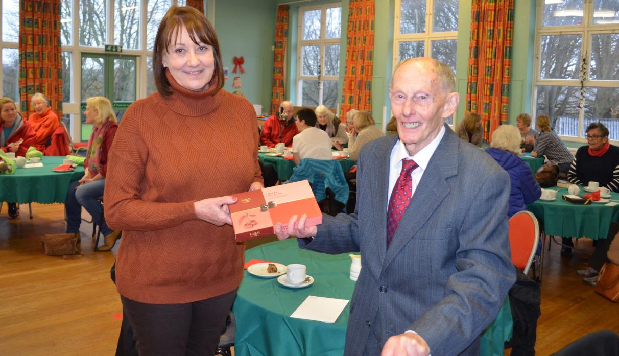 THANKS FOR EVERYTHING: Colin Clarke presents Debbie Herbert with a box of chocs and vouchers on behalf of the Startforth Lunch Club, which she ran for three years. Plans are being made for the club to return early in the new year