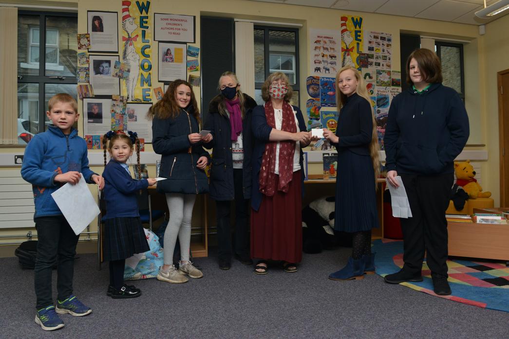 BOOK WORMS: Friends of Barnard Castle Library members Celia Chappell and Kim Harding hand over book tokens to prize-winners Archie Connor, Amelie Scott-Ash, Katie-Marie Blackburn, Mila Johnson and Rosie Wright