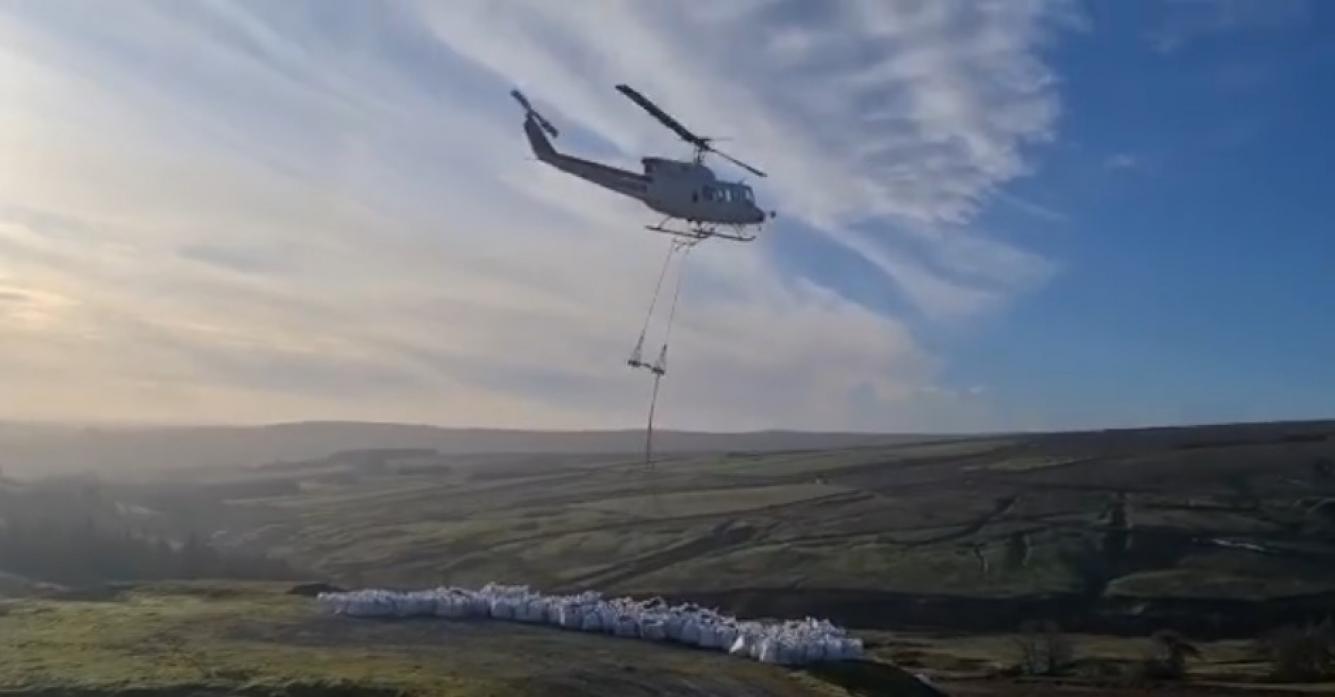 HEAVY LOAD: A helicopter transporting harvested heather brash from to peat sites being restored