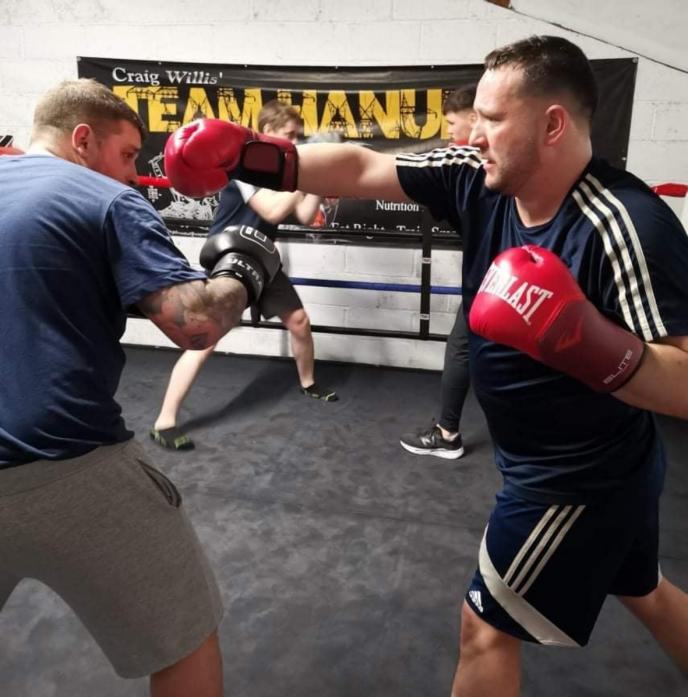 HARD HITTING: Dave Short, right, is in training for a boxing bout to raise money for Cancer Research UK