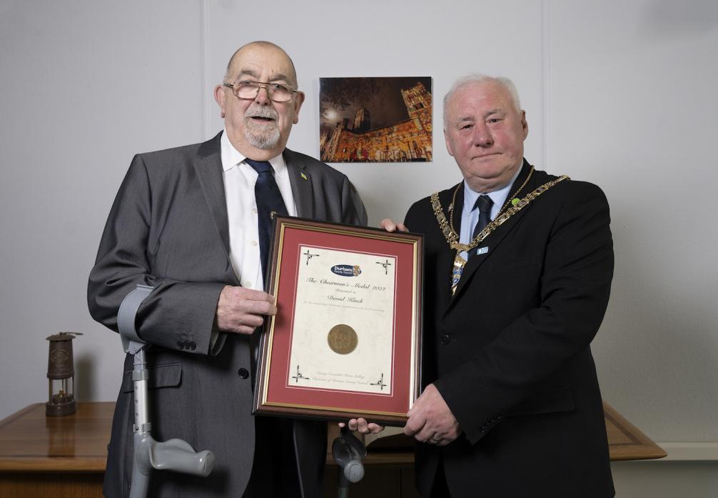 COMMUNITY SERVICE: David Kinch, left, receives his chairman’s medal from Cllr Watts Stelling