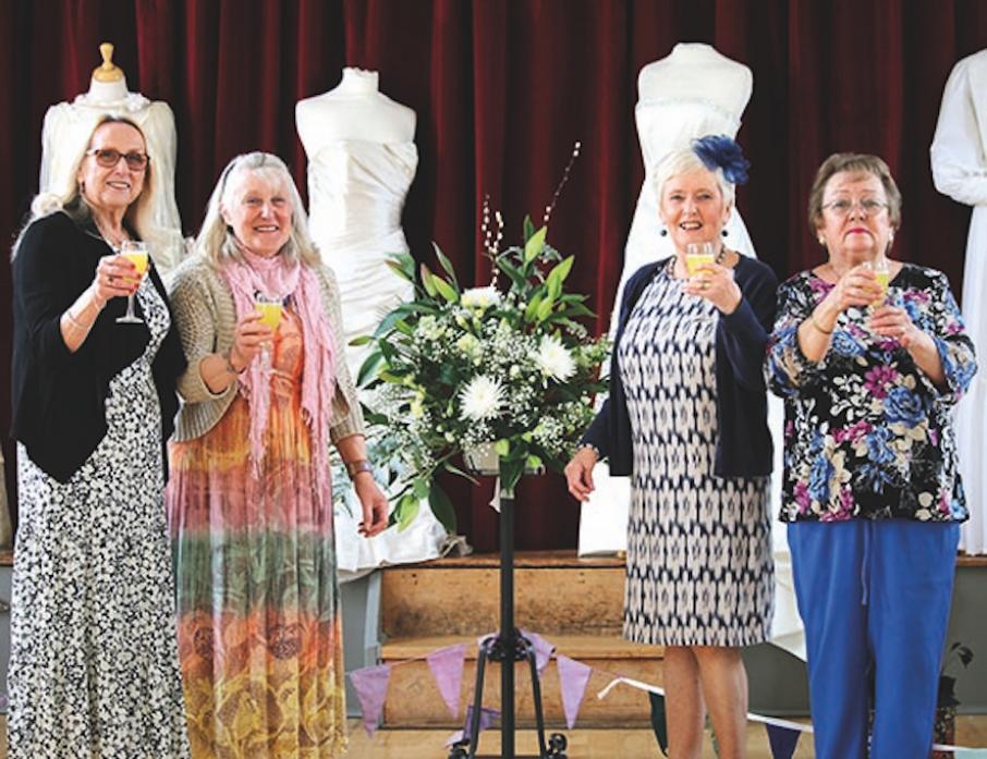 CHEERS: Village hall committee members Alison Banner, Joan Marwood, vice-chairwoman and event organiser, Val Ramshaw, chairwoman, and Carol Heslop raise a glass to the success of their wedding exhibition