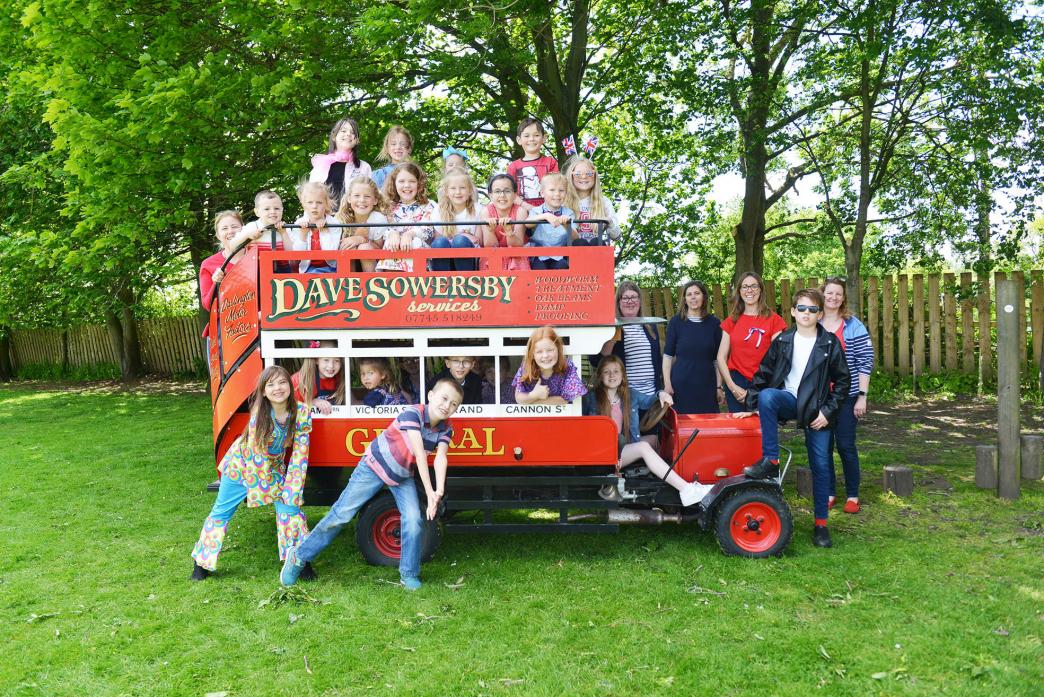 TOUR BUS: Children hop aboard for a tour on David Sowersby’s miniature bus  					TM pic