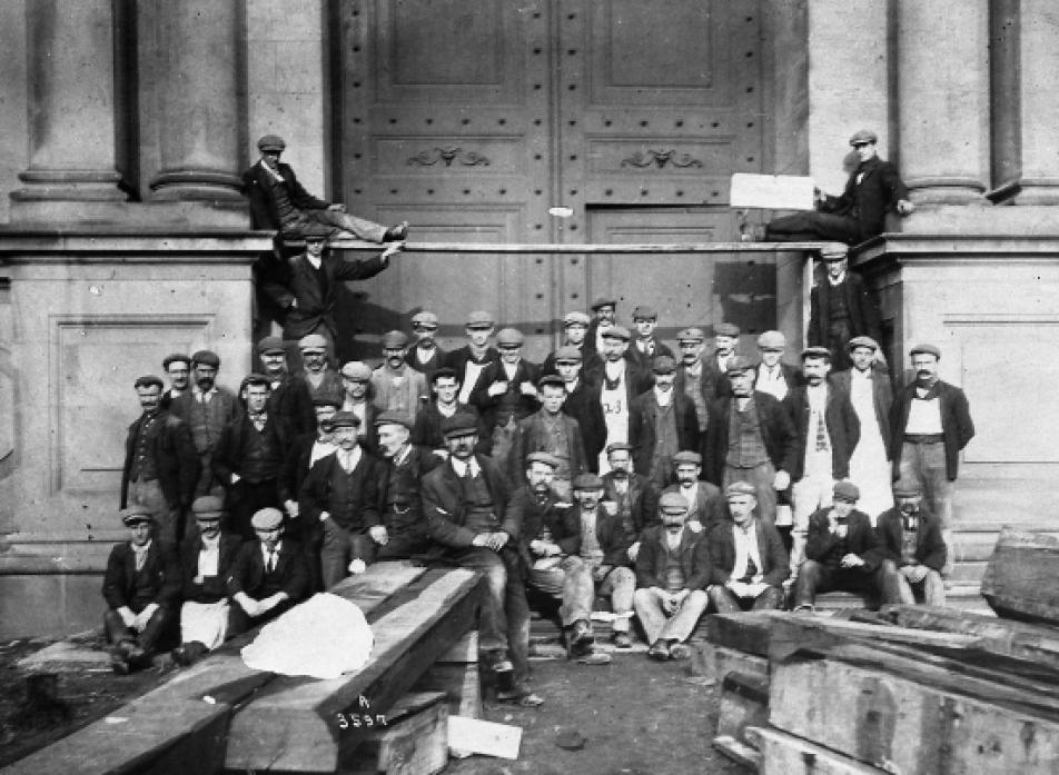 TAKING A BREAK: A group of workmen pose outside the front doors of the museum in about 1905 (probably the time the rotten oak beams were being replaced with steel girders)