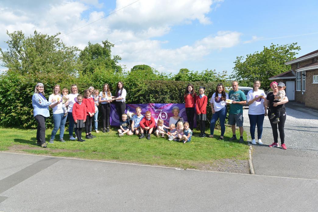 CASH HELP: Mums from Butterknowle hand over cash raised during a jubilee event they organised to a representative of the village’s Sea Scout troop, the village hall, toddler group and Friends of Butterknowle School  										             TM pic