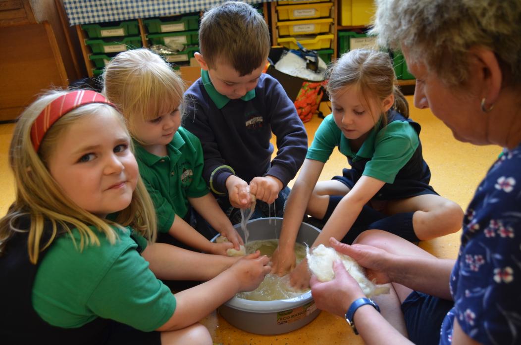 CLEANING UP: Children at Cotherstone Primary tried their hands at washing and cleaning wool ready for carding TM pic