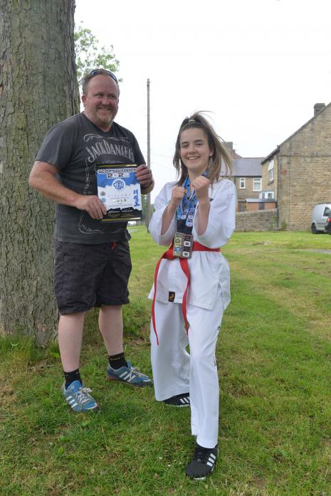 SIMPLY THE BEST: Chloe Simpson shows off her gold Scottish championship medal while proud dad Nicky displays her certificate  					    TM pic