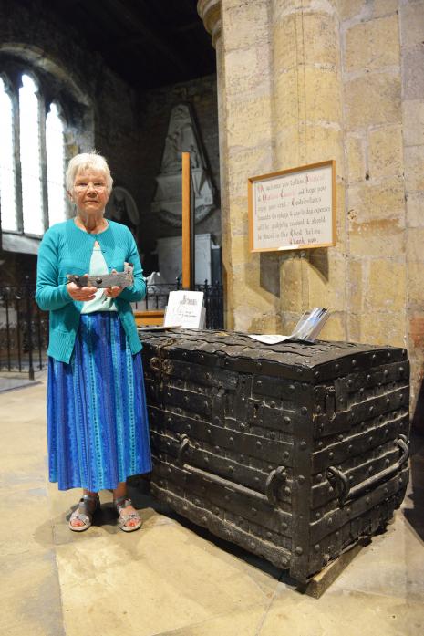 DAMAGE: Church warden Joan Harrison with metal that was prised from the ancient chest at St Mary’s Church