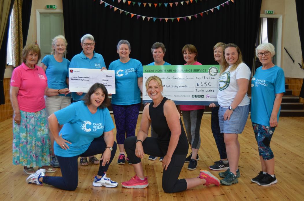 GOOD TIME: Cotherstone Zumba Ladies presented Teesdale branch of Cancer Research UK and the Great North Air Ambulance Service with bumper donations raised during a charity night  							TM pic