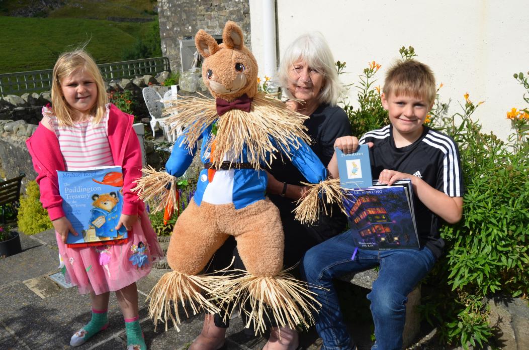 SCARY STUFF: Isla and Jake Lee-Ayre with Alison Thompson, who created her Peter Rabbit scarecrow, complete with carrots, out of a fancy dress costume TM pic