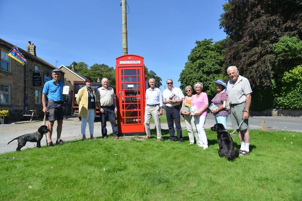 DIALLING UP SUCCESS: Teesdale Action Partnership’s Annalisa Ward, Cllr George Richardson, parish chairman Cllr George Stastny, Whorlton Community Association chairman Chris Connolly and enthusiastic villagers prepare to stock Whorlton’s new telephone box