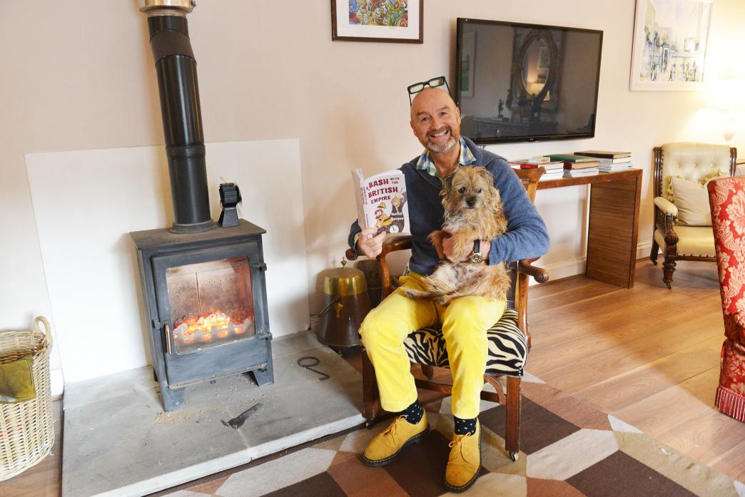 FIRESIDE AUTHOR: Celebrity antiques dealer David Harper and dog Rosie with his latest book A Bash With The British Empire