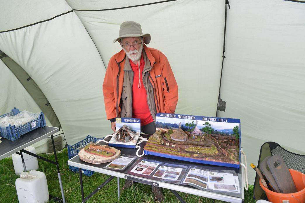 BACK IN TIME: Tony Metcalfe, chairman of Altogether Archaeology, with the model of the Iron Age settlement TM pic