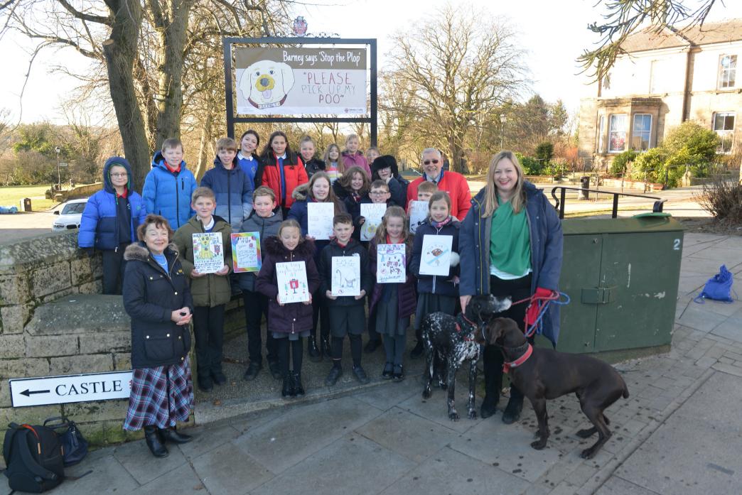 PICK IT UP: Town councillors Fiona Turnbull, Valerie Ewart and Chris Foote-Wood with creative pupils from Green Lane and Montalbo primary schools with some of the signs they designed for Barnard Castle’s anti-dog fouling campaign TM pic