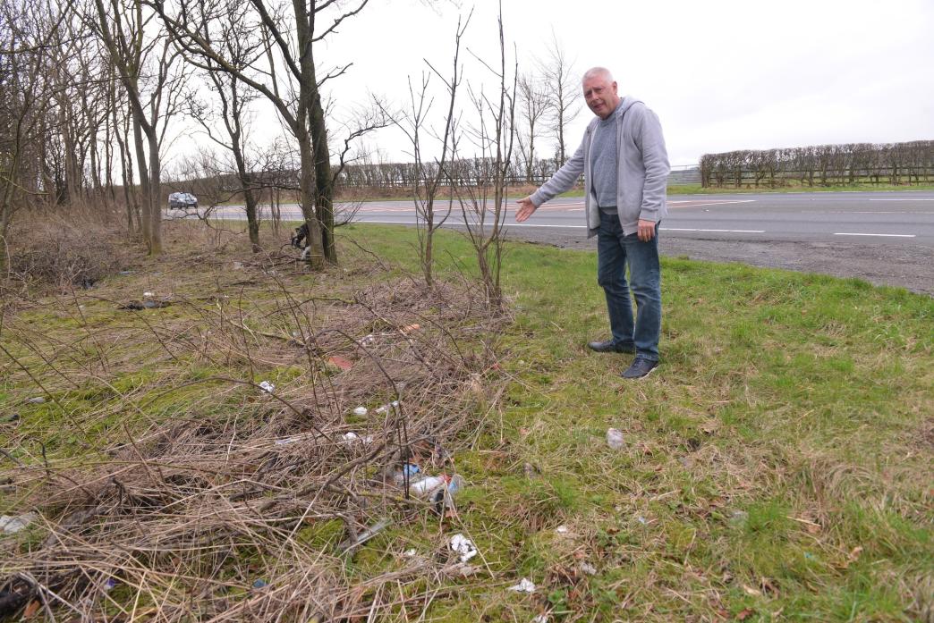 CLEAN IT UP: Newsham parish councillor Chris Brown highlights the rubbish on the A66            TM pic