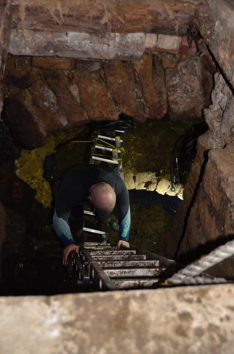 DEEPER AND DOWN: Ian Mitchell descending into the well