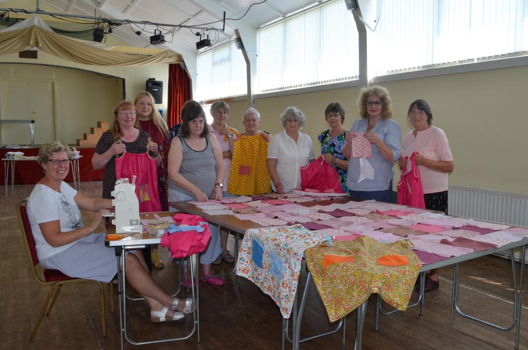 IT’S STITCH UP: Women gathered at Bowes Village Hall to sew dresses and quilts for charity
